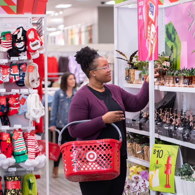 A Target guest shopping in a section full of holiday items.