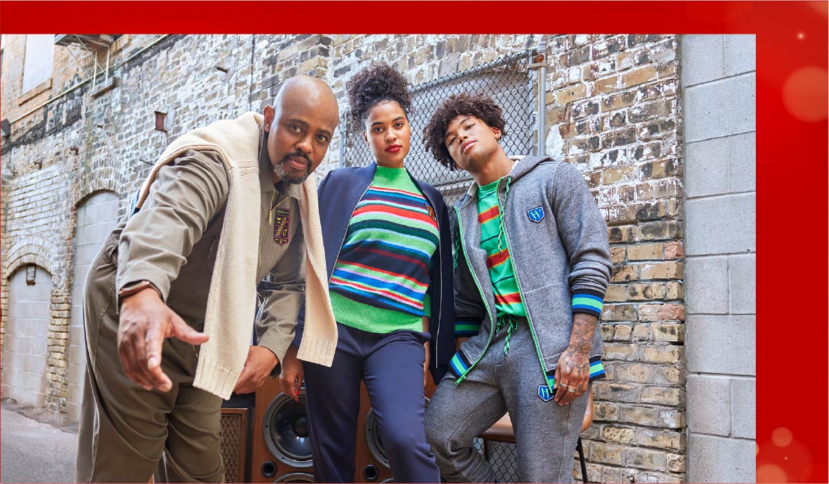 Houston White and two models standing outside in front of a brick wall wearing apparel from the Houston White x Target collection.