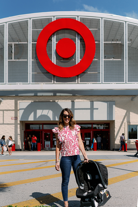 Jacky stands outside the Target store carrying a car seat