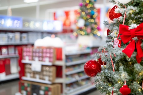 Tree decorations are displayed near a Christmas tree display.