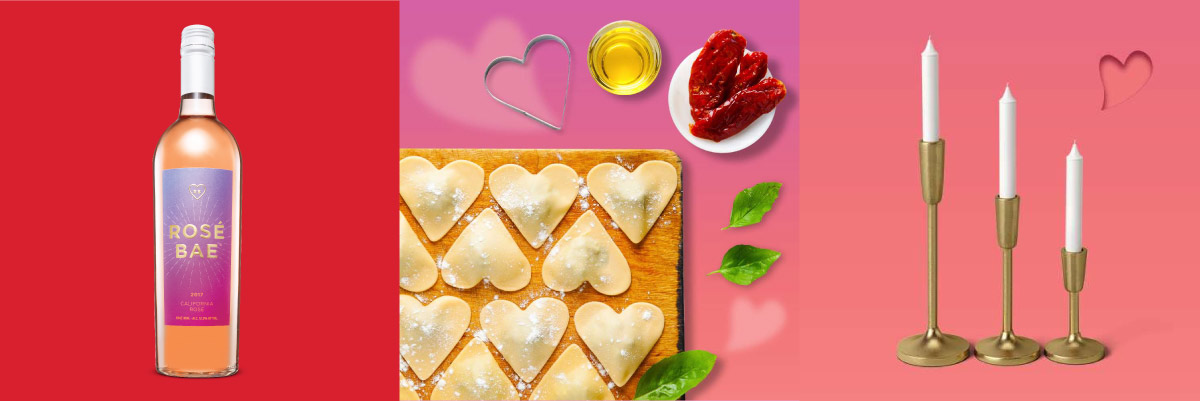 A bottle of rosé wine, heart-shaped pasta and gold candlesticks.