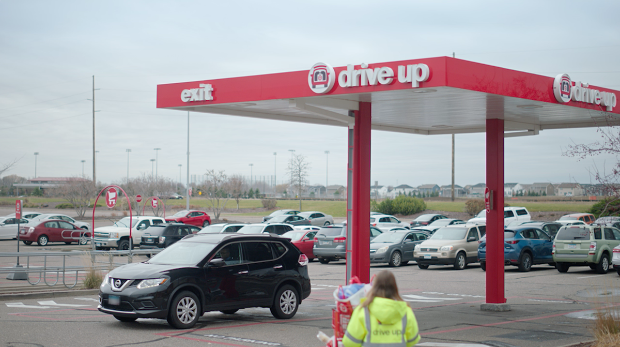 a person standing in front of a car parking lot with cars