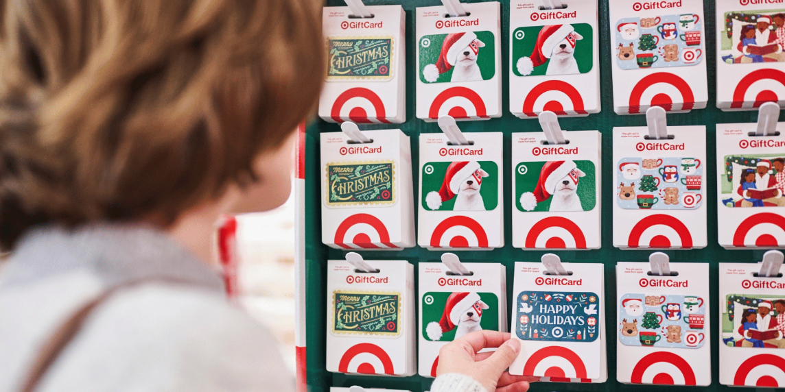 A guest browses Target GiftCards, grabbing one that says "Happy Holidays."