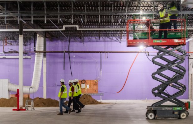 a group of men in hardhats working on a construction site