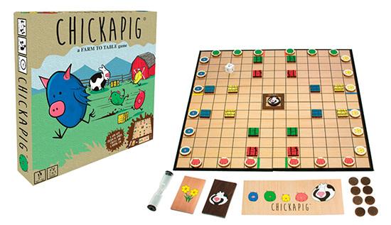 The Chickapig board game box sits next to an assembled playing board with cards and pieces