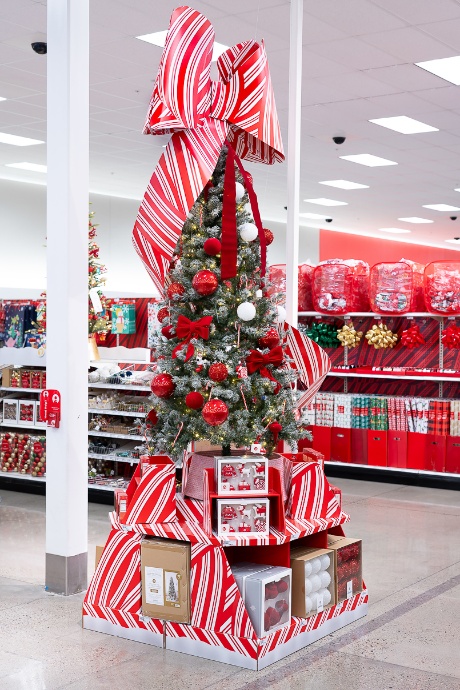 A Christmas tree is on display, topped with a red-and-white striped bow.