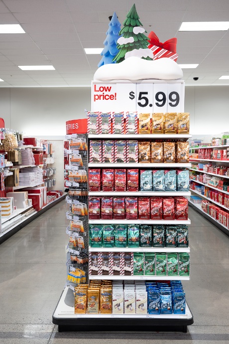 A sign that says “Low price! $5.99” is at the top of an endcap full of holiday chocolates.