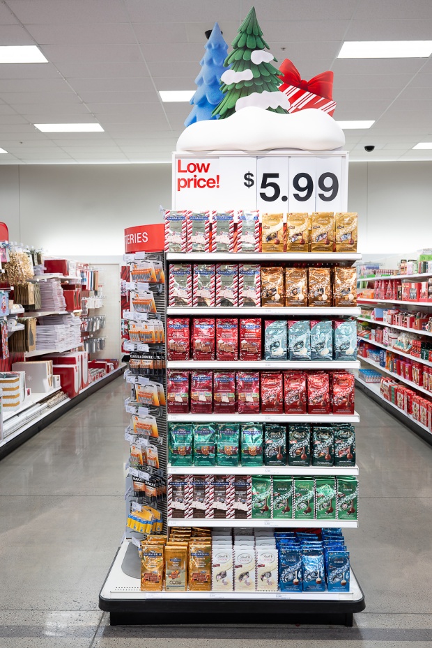 A sign that says “Low price! $5.99” is at the top of an endcap full of holiday chocolates.