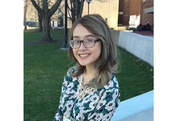 A head-and-shoulders shot of PaNa standing on a grassy yard