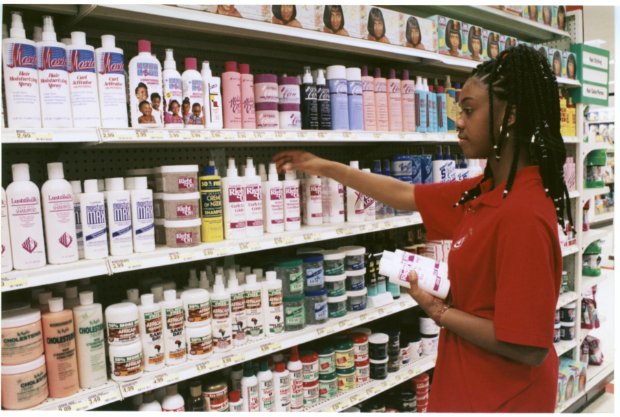 a person standing in front of a shelf of products