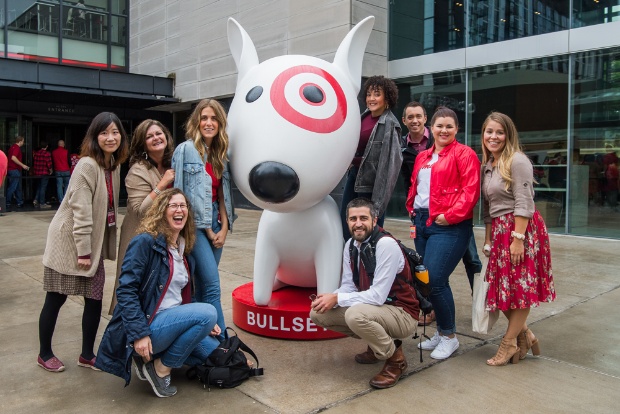 a group of people posing with a person in a rabbit garment