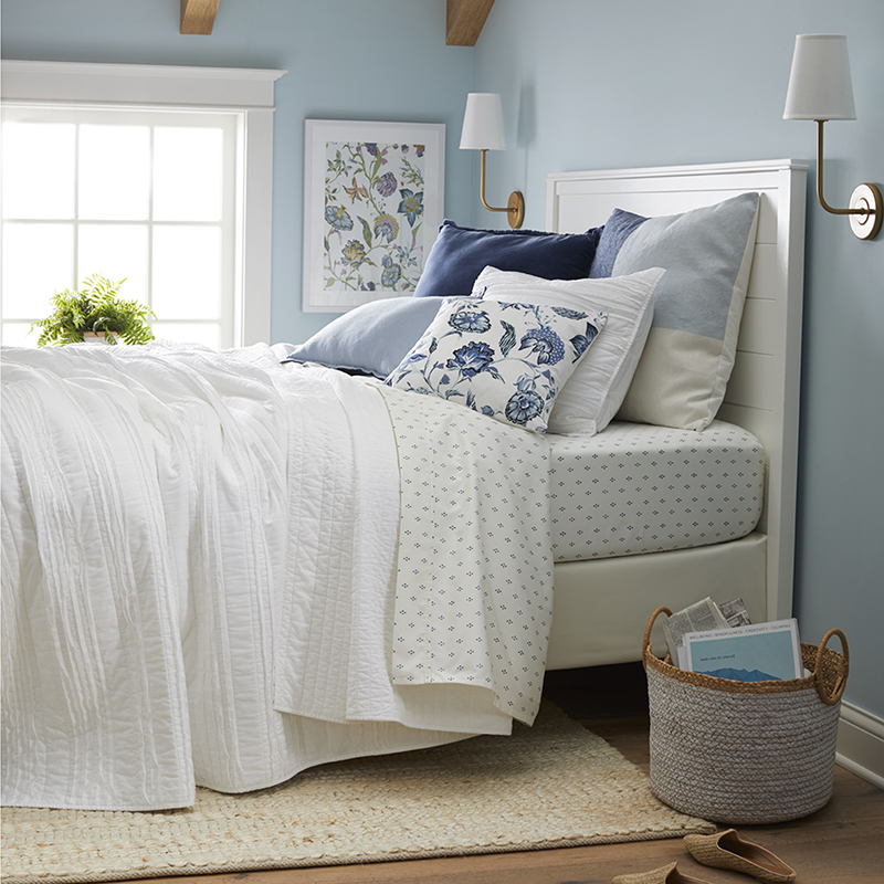 A bedroom bedecked in crisp whites and cool blues