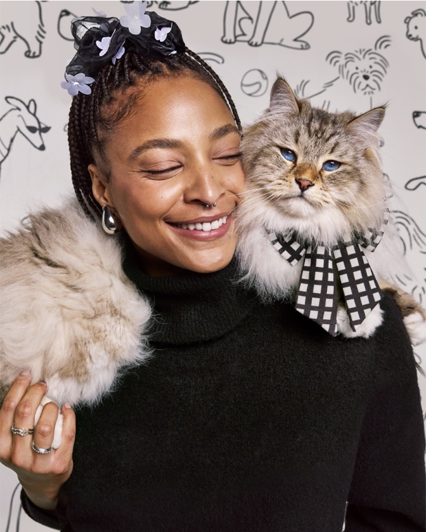 A model poses with a cat wearing The Cuddle Collab collection.