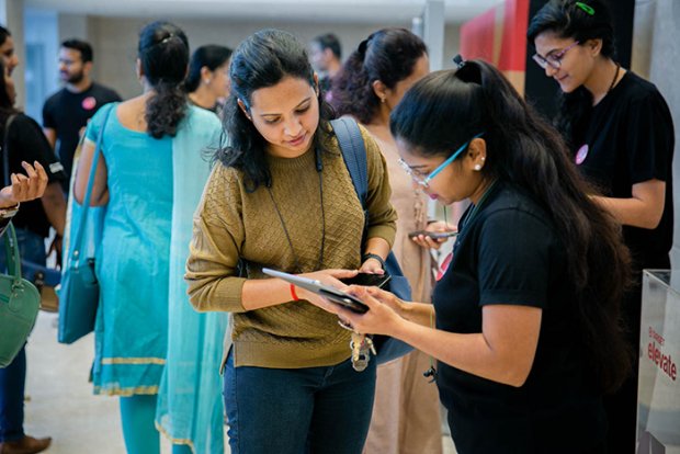 a person showing a person something on a tablet