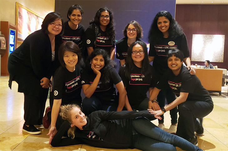Ten women wearing Target Tech team t-shirts pose together in their workspace