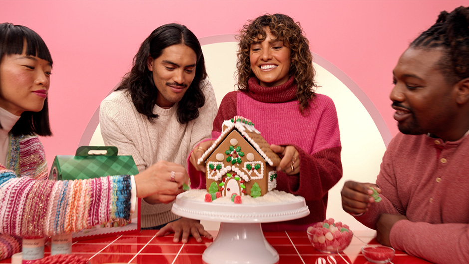 a group of people around a cake