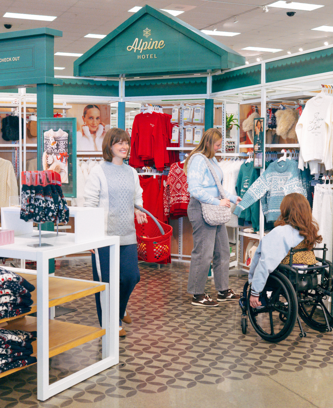 People shopping for cozy holiday gear in the Alpine Hotel display of a Target store.