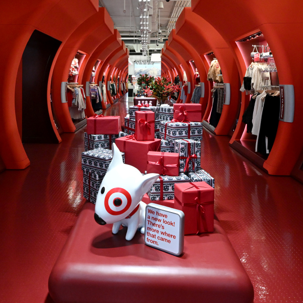 A red background of a line drawing of the New York City skyline with a picture of the entry of the Target SoHo store.
