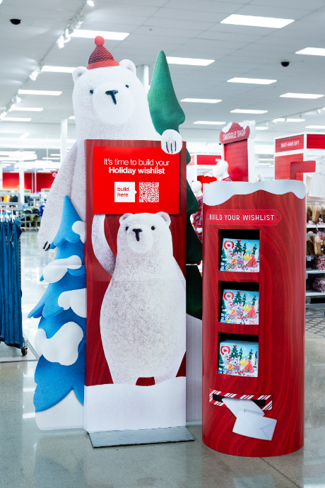 A large Berry the Bear cutout holds a sign with a QR code and the words “It’s time to build your holiday wishlist.”