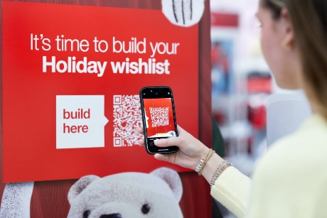 A person is scanning Target’s Holiday Wishlist QR code with their cell phone.