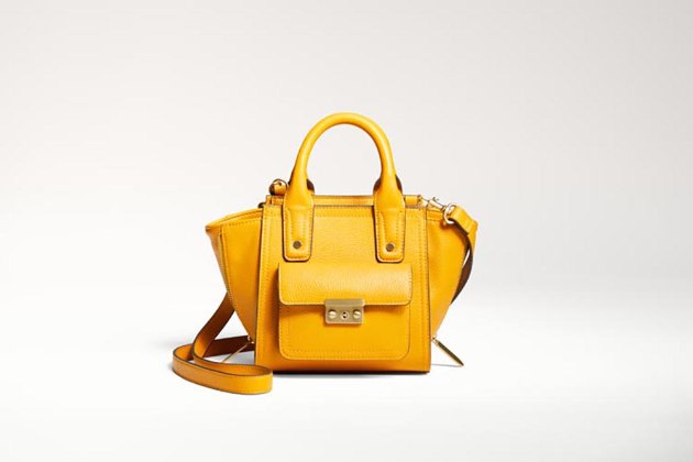 a yellow handbag on a white background