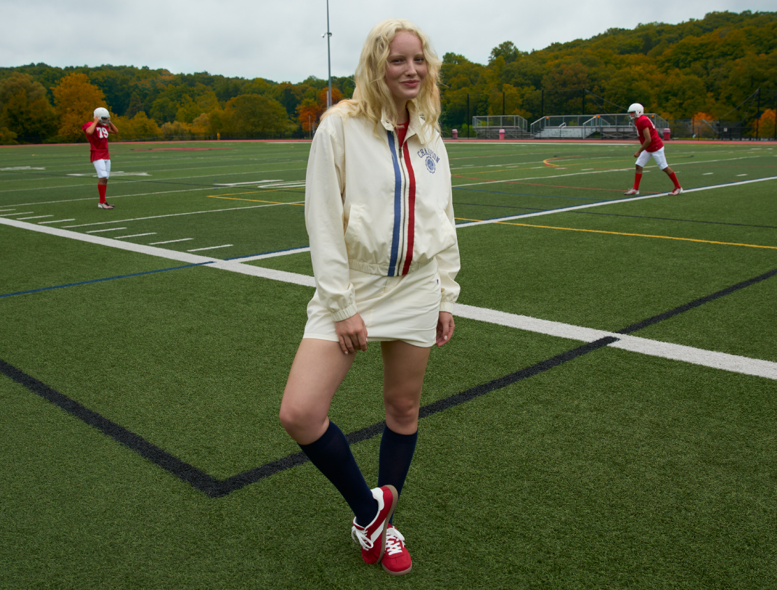 a person in a white uniform on a football field