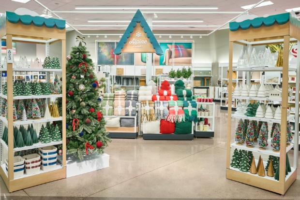 Store display featuring holiday décor, trees and cozy winter accents under an Alpine Chalet sign.