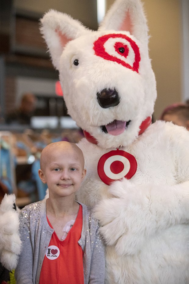 a boy standing next to a person in a garment