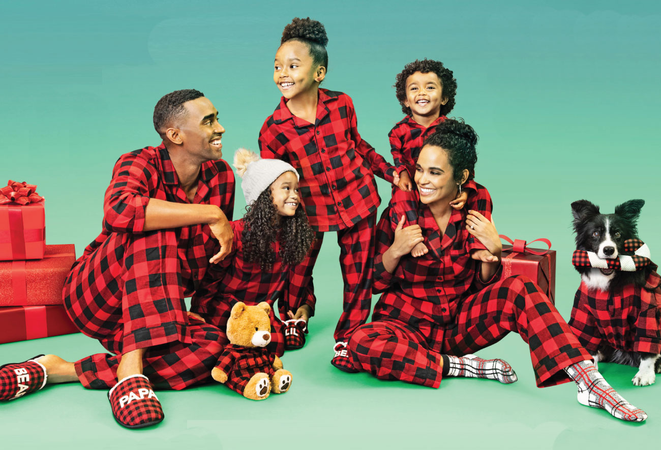 A family of five wears matching buffalo plaid pajamas