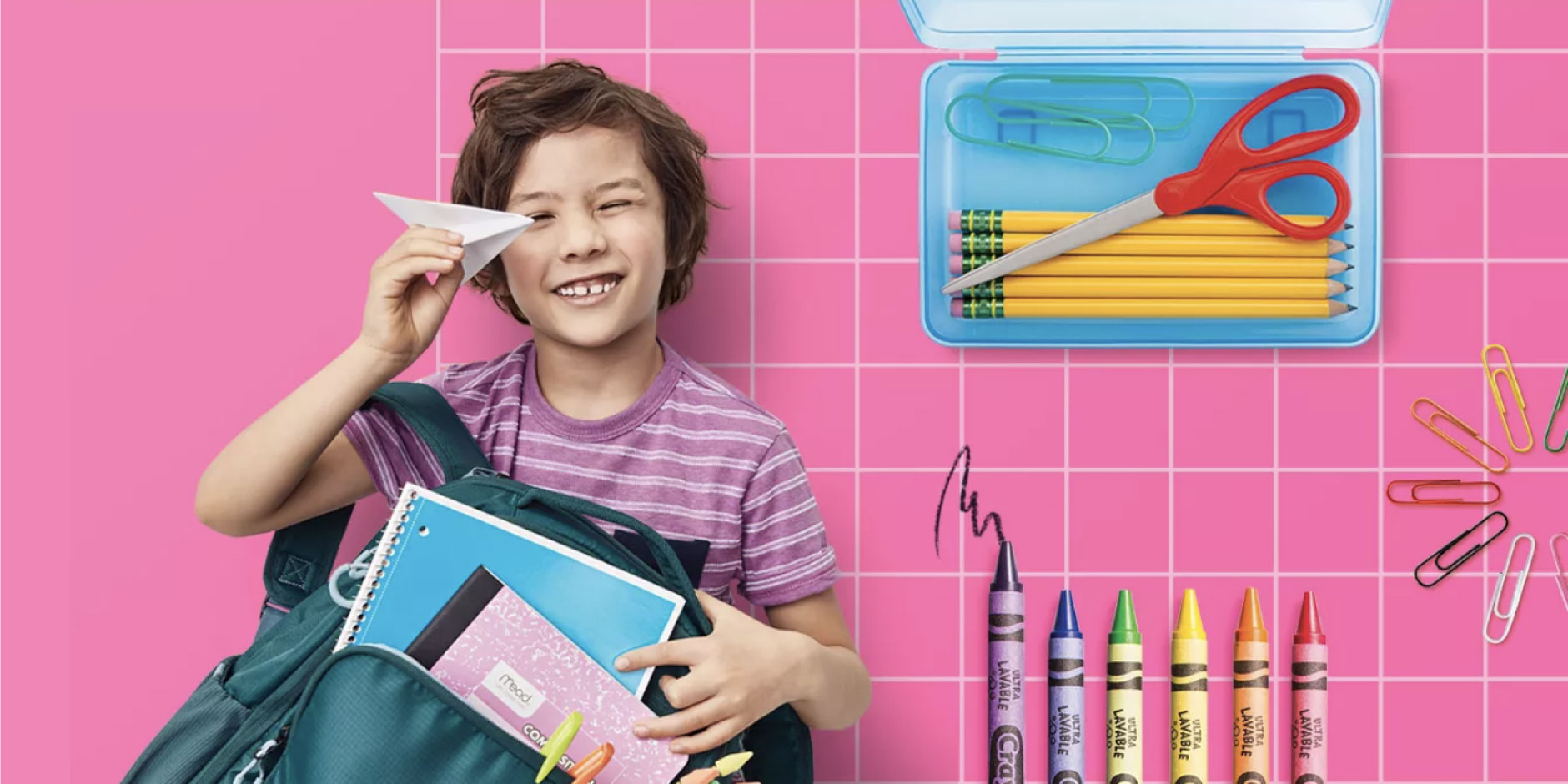 a boy holding a book and a pencil in his hand