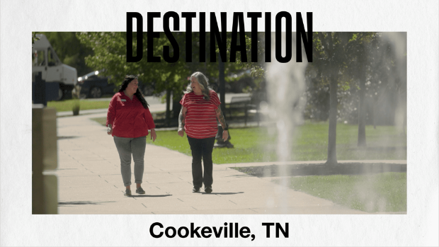  A video still with playback button for Destination Cookeville with two team members walking together.