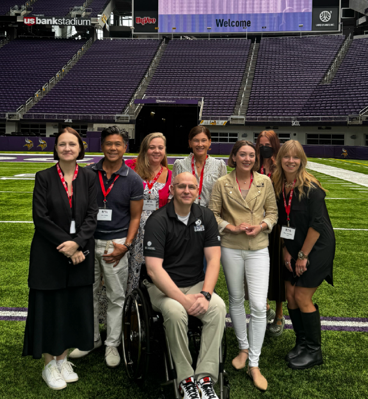 a group of people posing for a photo on a sports field