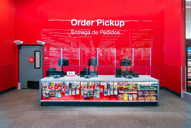 a red wall with a display of bottles and cans on it