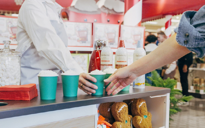 A person grabs a sample of a seasonal beverage.