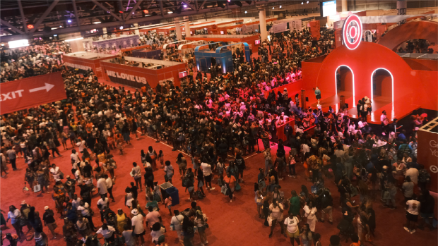 A large crowd gathered around a red stage and installation, featuring a large Bullseye logo on top.