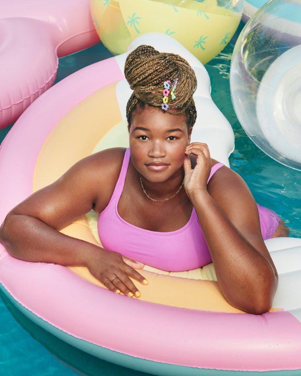 a woman in a pink dress in a hot tub