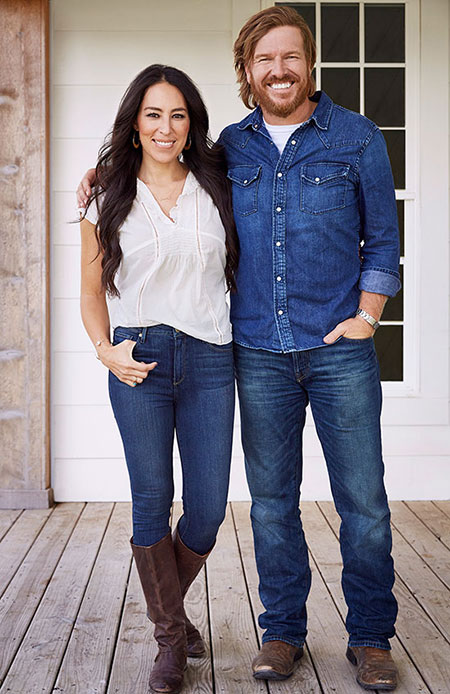 Chip and Joanna standing together in front of a house