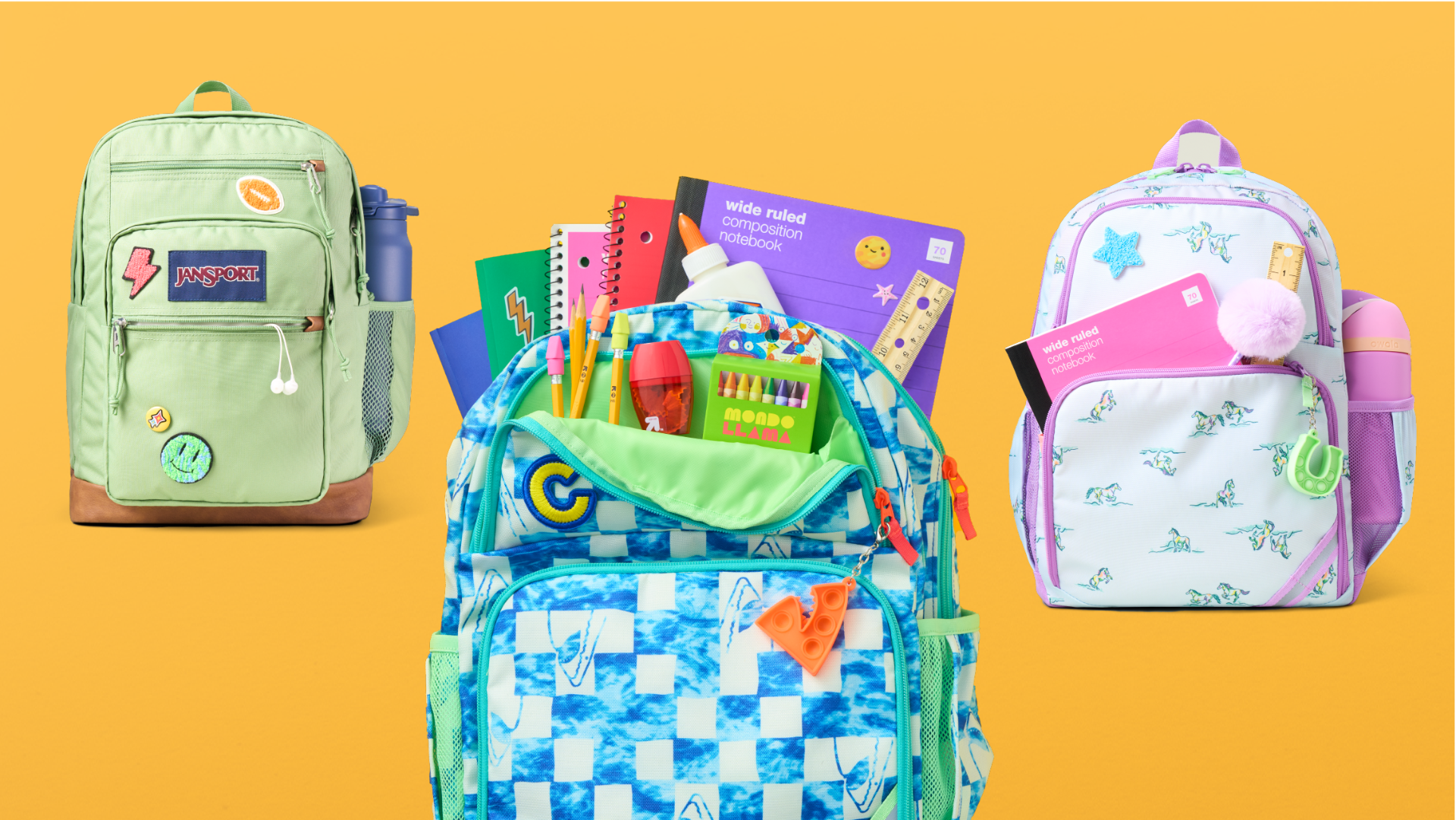 Three personalized backpacks filled with school supplies.