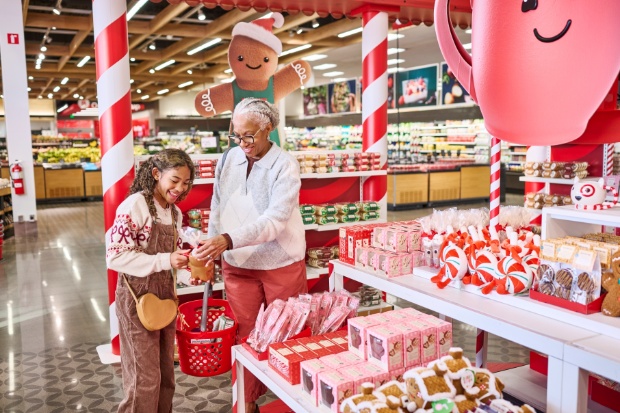 A detailed view of guests exploring products in the Hot Cocoa Club display inside a Target store.