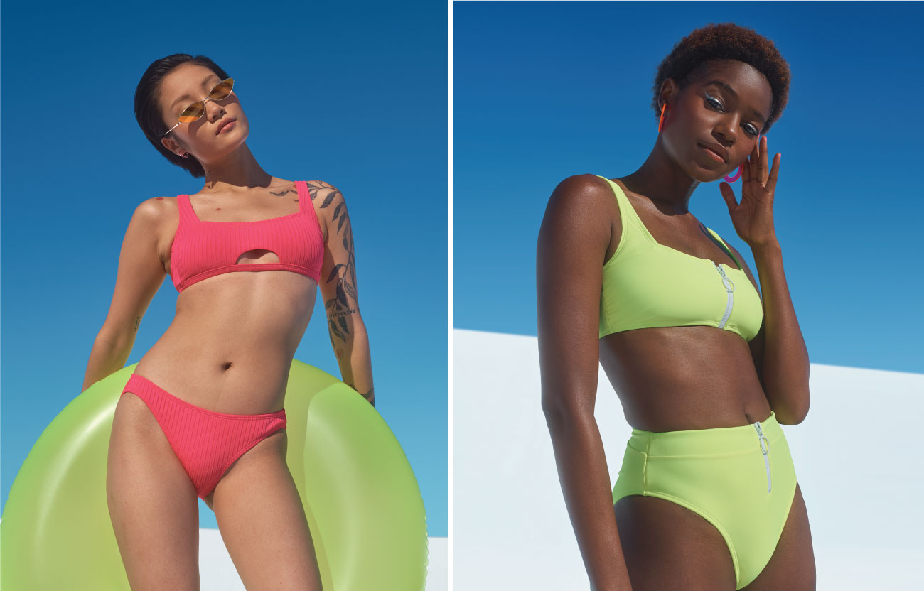 Two women in swimwear, one in a bright pink bikini and one in a lime green bikini with zipper detail