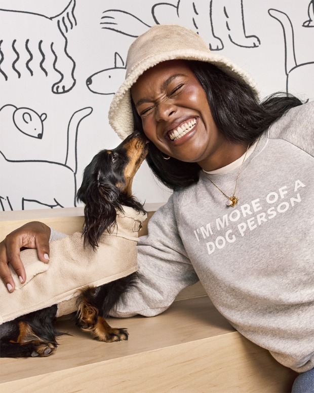 A model and dog pose wearing The Cuddle Collab collection.