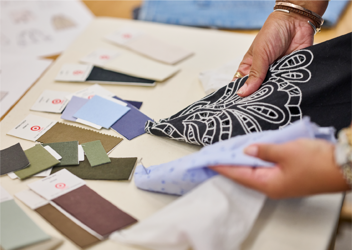 A person holds two pieces of fabric.