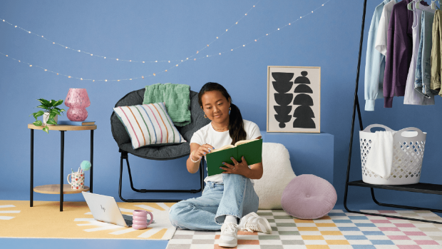 a person sitting on a couch with a laptop