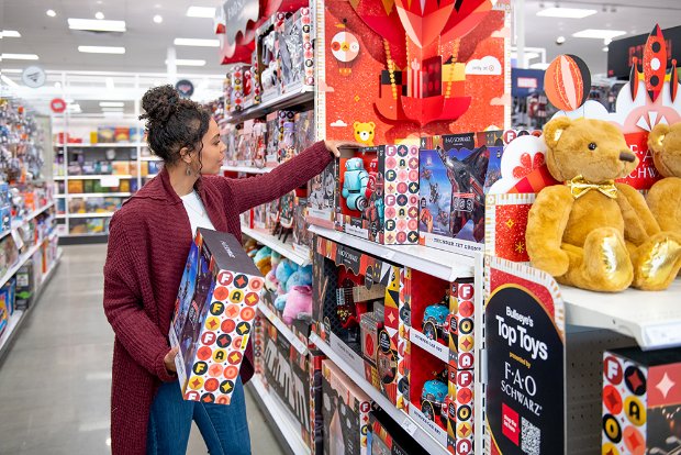 a person in a store with a large stuffed bear