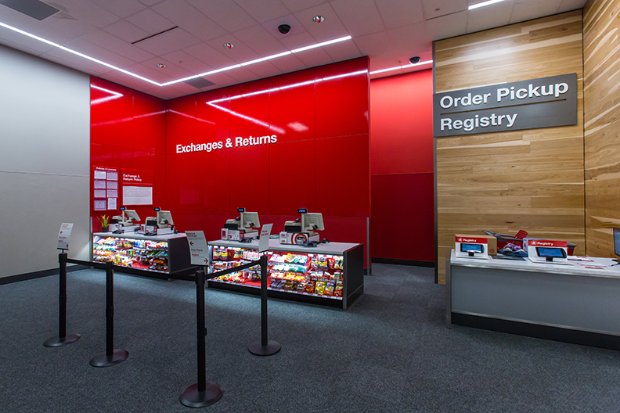 a red wall with a sign and a table with objects on it