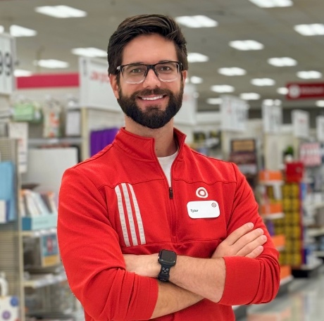 Target team member Tyler smiles for a photo in a Target store.