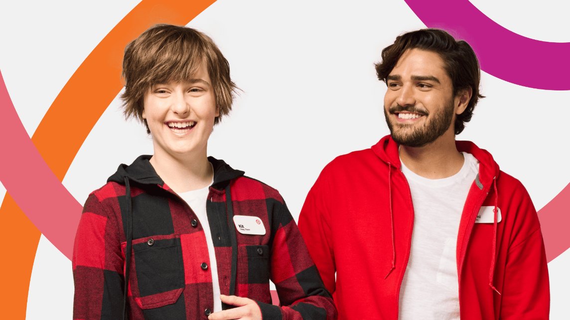 Two people smiling in front of a colorful background