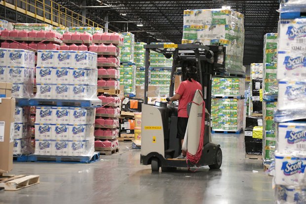 a person pushing a cart full of boxes