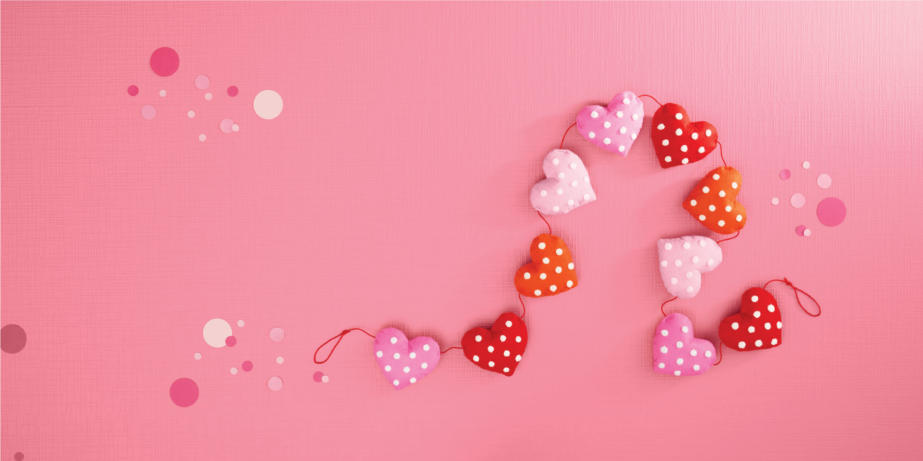 a pink background with red and white candies