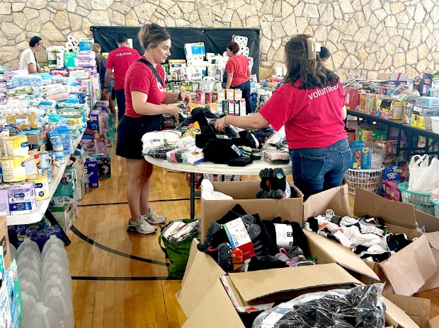Two adults in Team Target gear sort through a pile of donated goods.